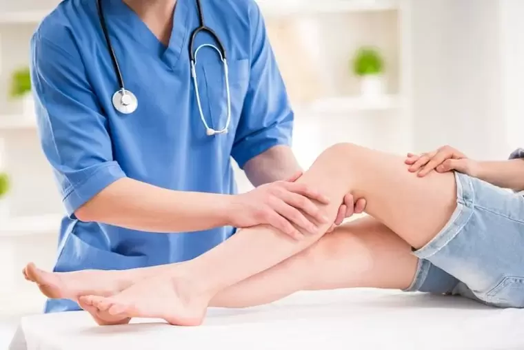 Doctor checking leg for varicose veins